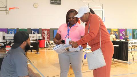A woman helping another woman with her taxes.