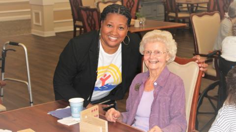A staff member with an elderly woman.