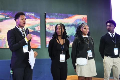 Students speaking to the audience.