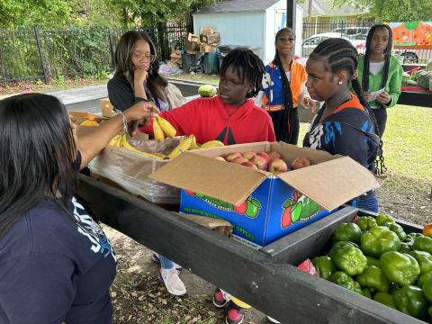 Children grabbing fruit.